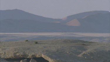 sand dunes in distance through heat haze