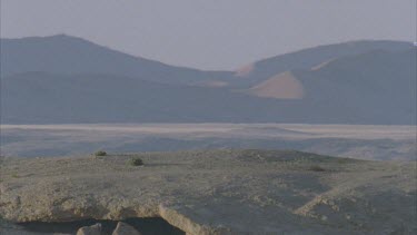 sand dunes in distance through heat haze