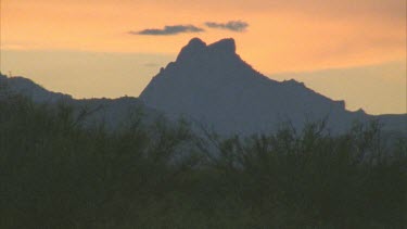 silhouette of mountain against sunrise or sunset