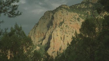 Chiricahuan mountains sandstone cliff face with dark rain clouds behind