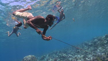 Fishermen spearfishing underwater