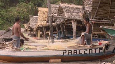 Fishermen untangling a net