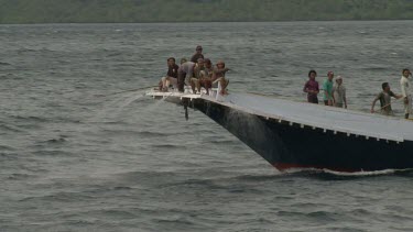 Fishermen trawling on a large fishing boat