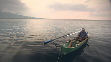 Maumere local in a canoe at sunset