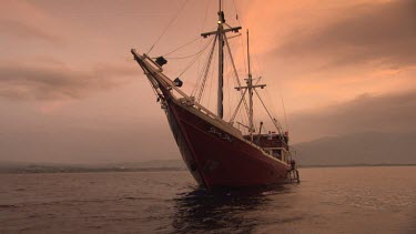 Seven Seas ship heading away at dusk