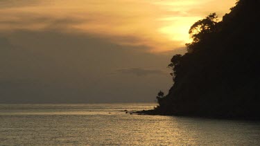 Sunset over Komba volcano and the coast