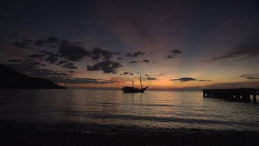 Seven Seas ship anchored in a bay at sunset