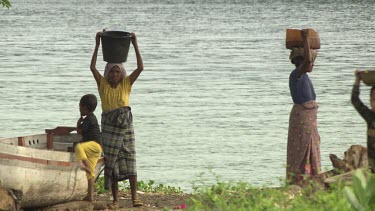 Village girls with buckets on their heads