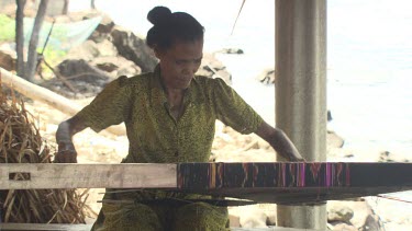 Close up of a woman weaving