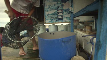 Fisherman weighing a caught fish in a net