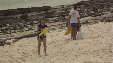 Family exploring a rocky beach