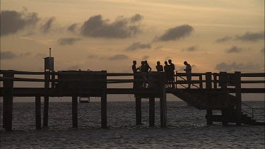 People at the Pier on Heron Island at sunset