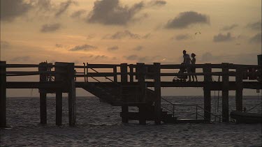 People at the Pier on Heron Island at sunset