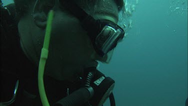 Diver holding worm in hands.