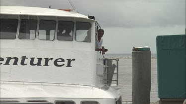 CU Ferry arrives to the dock. People are waiting for a ferry.