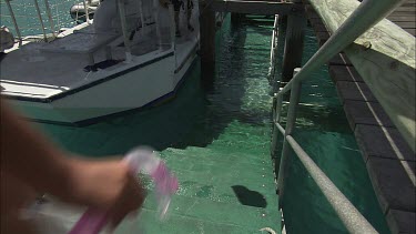 Two girls on the warf going for a diving.