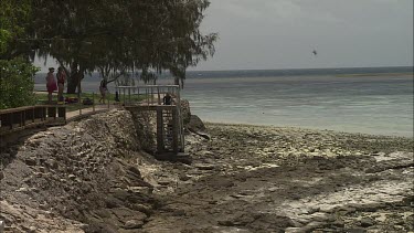 Low tides. Kids are playing at rocks. Kids are going to do snorkeling.