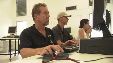 Student researchers working on computers