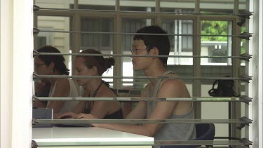 Student researchers working on computers