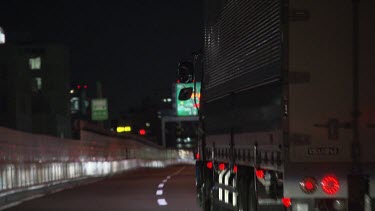 Large truck driving on a highway at night