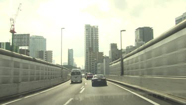 Traffic driving on a bridge into the city