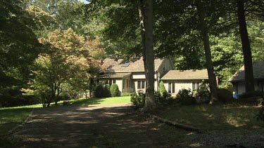 Large stone house with a lush garden in the countryside