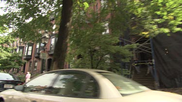 Cars parked in front of an elegant brick apartment