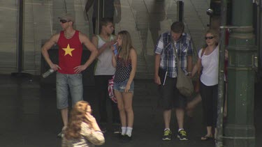 Pedestrians waiting at a busy crosswalk