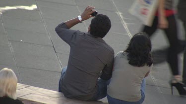 Couple takes pictures at a tourist site