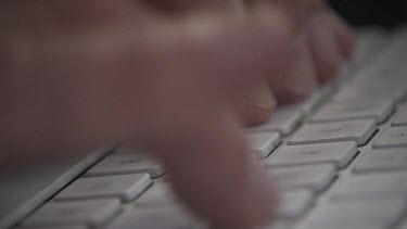 Close up of a person typing on a keyboard