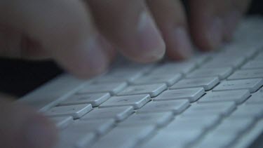 Close up of a person typing on a keyboard