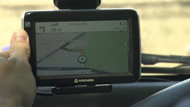 Person configuring a GPS on their car's dashboard