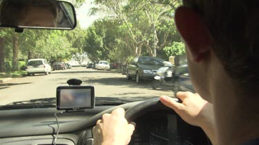 Driving a car with a GPS on the dashboard