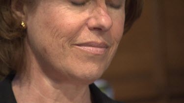 Close up of a woman singing in a church choir