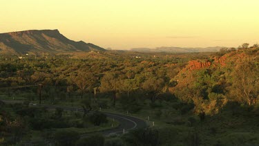 Winding road through a forest at dusk