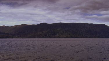 Rocks and mountains along the edge of a river