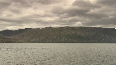 Rocks and mountains along the edge of a river