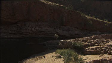 Bright sunlight streaming over a rocky cliff