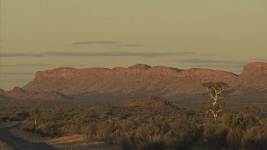 Red rocky mountain ridge and hazy landscape