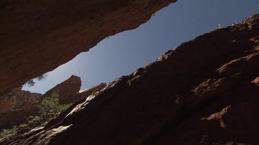 Blue sky seen from the narrow path between two high cliffs