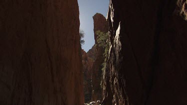 Blue sky seen from the narrow path between two high cliffs