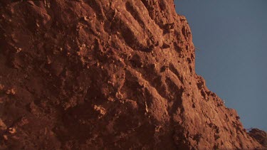 Close up of a red rocky dune on a beach