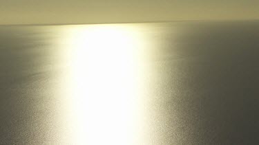 Sunlight reflected on the still ocean
