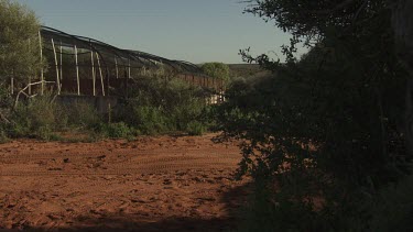 Row of fenced and covered animal enclosures