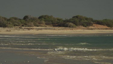 Gentle waves lapping on a sandy beach