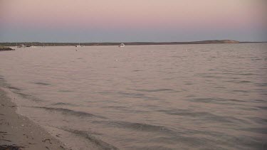 Gentle waves on the sand at dusk