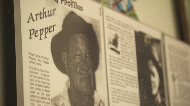 Close up of a black-and-white plaque of a cowboy