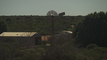 Farm buildings nestled in lush vegetation