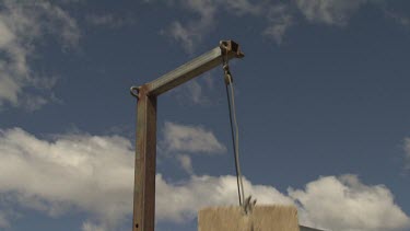 Cement cube hanging from a pulley