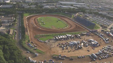 Car and colourful motor carts driving on a circular racetrack